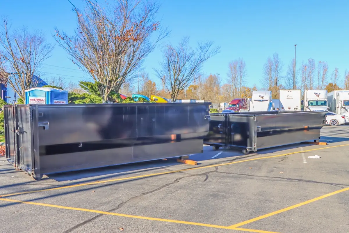 Professional dumpster rental service with roll-off container on residential driveway in Saginaw